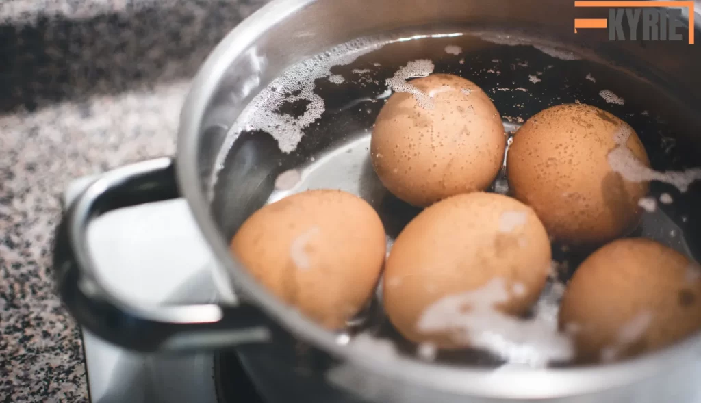 In the image, eggs are being boiled in water. The answer to "Can you freeze boiled eggs?" is yes, but only the yolks freeze well. The whites tend to become rubbery and lose texture when frozen.