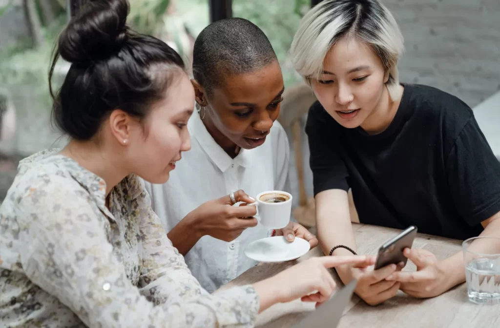 Three friends checking phone with green fn key